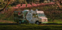 Central Kitchen Food Truck in a blooming peach orchard